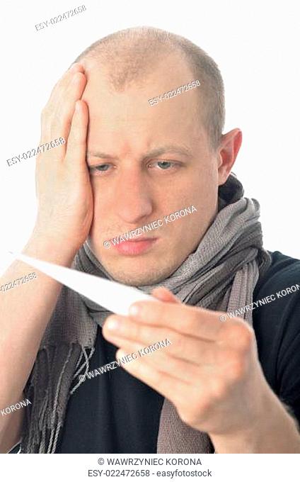 Man holding head in headache with thermometer in mouth