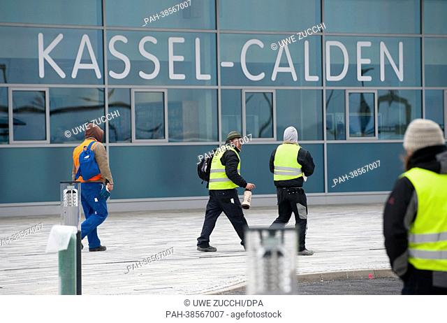 Construction workers walk past the terminal of Kassel Calden Airport in Calden, Germany, 03 April 2013. After about 15 years of planning