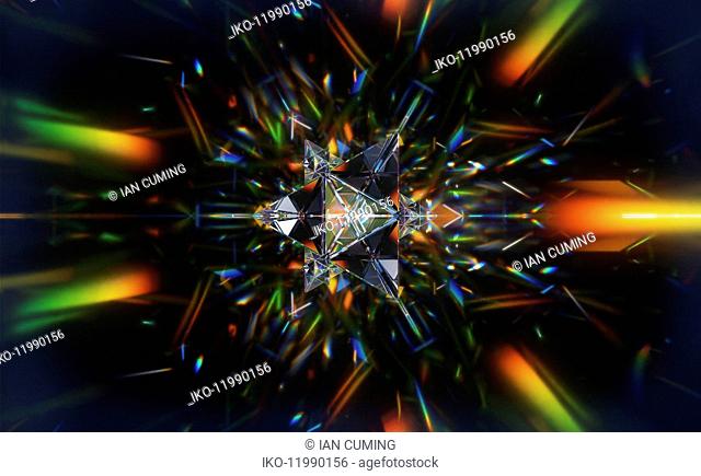 Abstract pattern of multicolored light trails and crystal triangle shapes