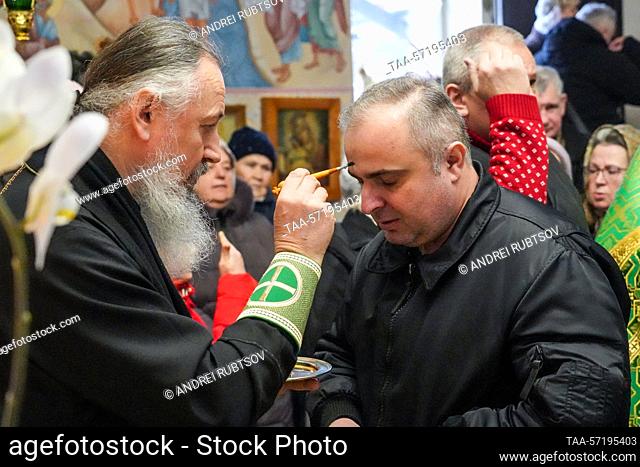 RUSSIA, MELITOPOL - FEBRUARY 5, 2023: A believer venerates the relics of St Sergius of Radonezh at the St George the Victorious Cathedral