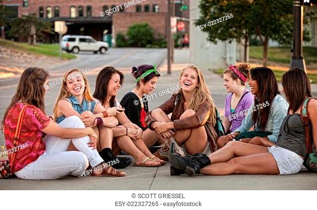 Eight Pretty Girls Sitting Outdoors