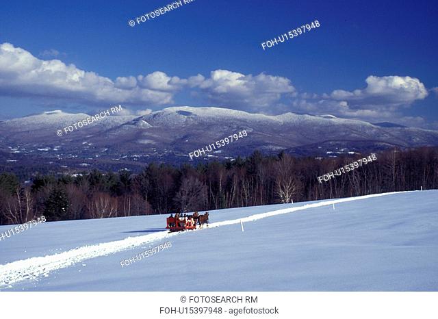 Vermont, Stowe, A sleigh ride in a snowy field with a scenic view of the Worcester Mountain Range from Trapp Family Lodge in Stowe.