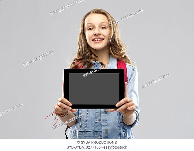 student girl with school bag and tablet computer