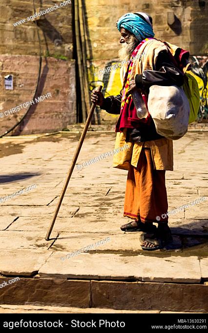 India, Varanasi, scenes at Dasaswamedh Ghat, beggars, stick