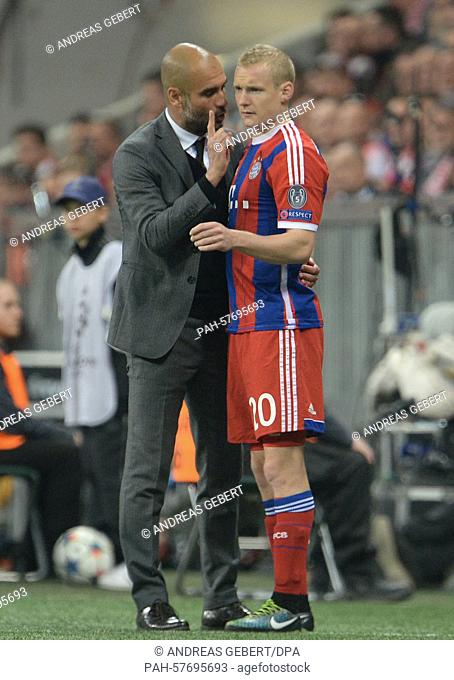 Munich's coach Pep Guardiola speaks with Sebastian Rode before his substitution at the Champions League quarter finals second leg match between FC Bayern Munich...