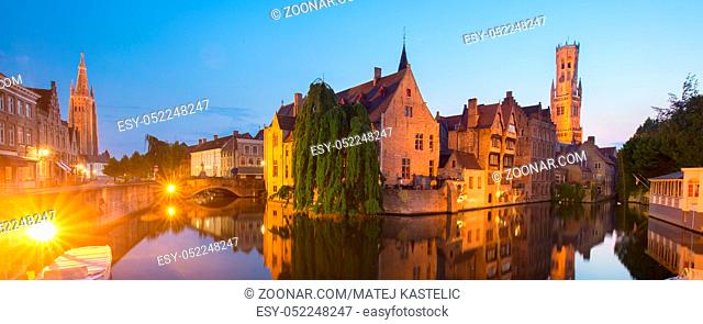 Panorama of Bruges, Belgium. Image with Rozenhoedkaai in Brugge, Dijver river canal and Belfort, Belfry, tower in twilight