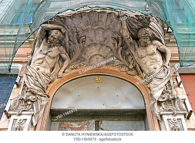 Atlantes supporting balcony above main entrance, restoration works of old building on Kosciuszki street number 21, Lodz, Poland, Europe