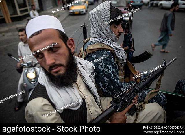 22 September 2021, Afghanistan, Kabul: Young Taliban fighters patrol the streets of Kabul on the back of a pick-up truck