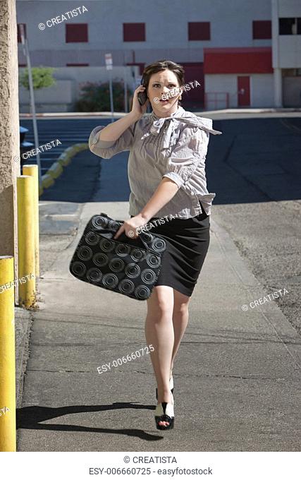 Woman is running down street late for meeting