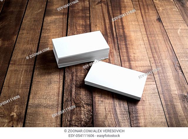 White paper business cards on wood background. Mockup for branding identity. Blank template for your design