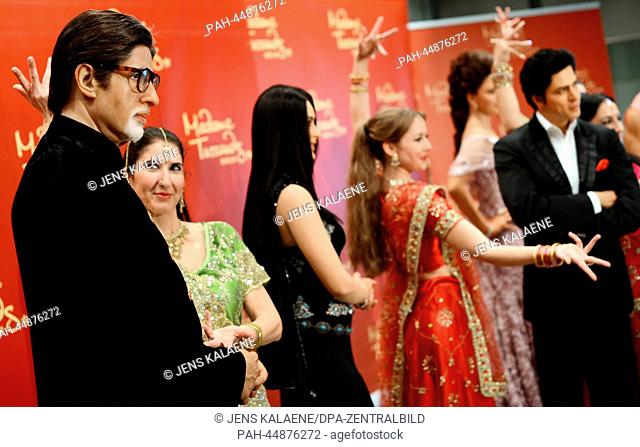 Dancers of a Bollywood dance group present the wax figures of Bollywood stars Amitabh Bachchan (L), Kareena Kapoor (3-L)