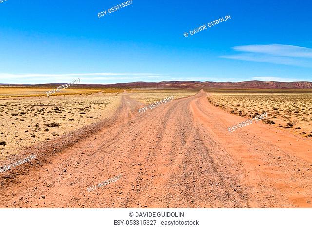 Bolivian dirt road perspective view, Bolivia. Andean plateau view
