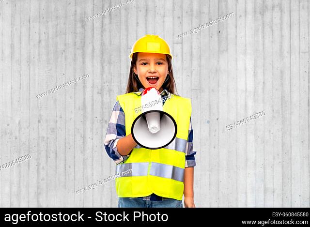 girl in helmet talking to megaphone over wall