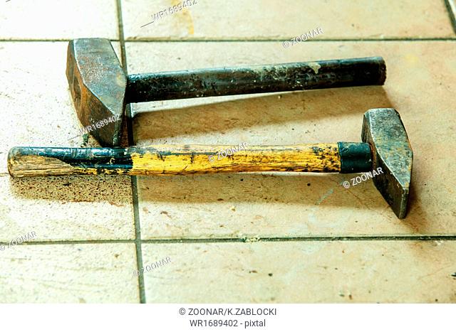 Two old sledge hammers hand tools in mechanic garage car service