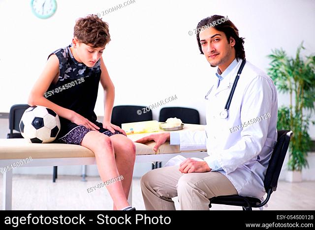 The boy football player visiting young doctor traumatologist