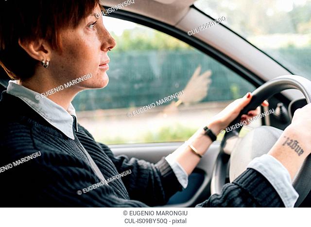 Woman concentrating on driving car