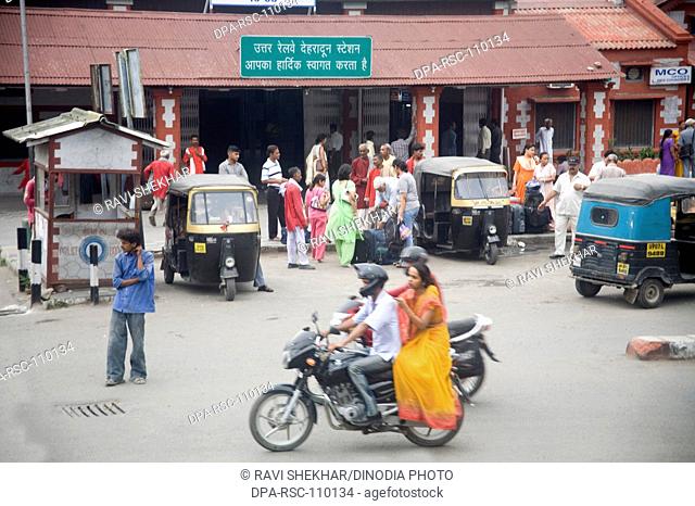 Couple on motorbike outside Dehradun railway station ; Dehradun ; Uttaranchal ; India
