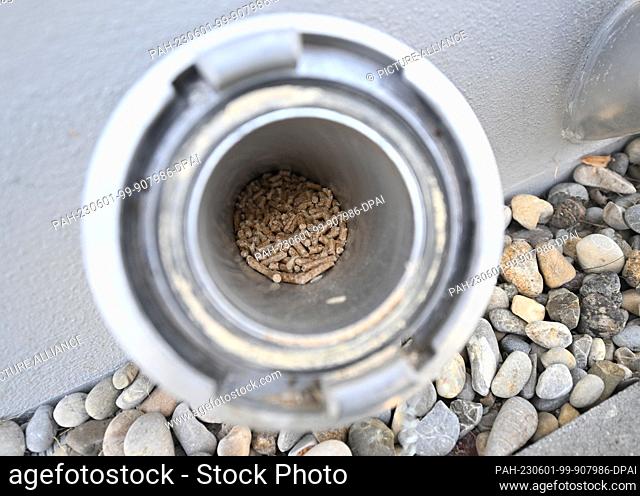 25 May 2023, Bavaria, Augsburg: The filling of a pellet heating system on the exterior wall of an apartment building - - taken during a field trip along the...