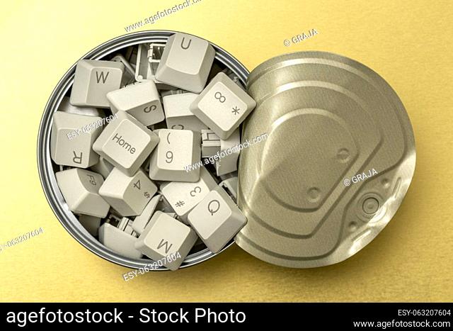 Knowledge and information seeking concept: tin can full of computer keyboard keys on the golden background
