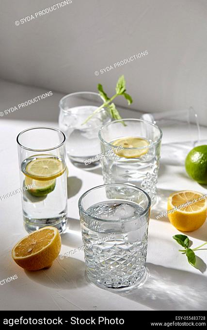 glasses with lemon water and peppermint on table