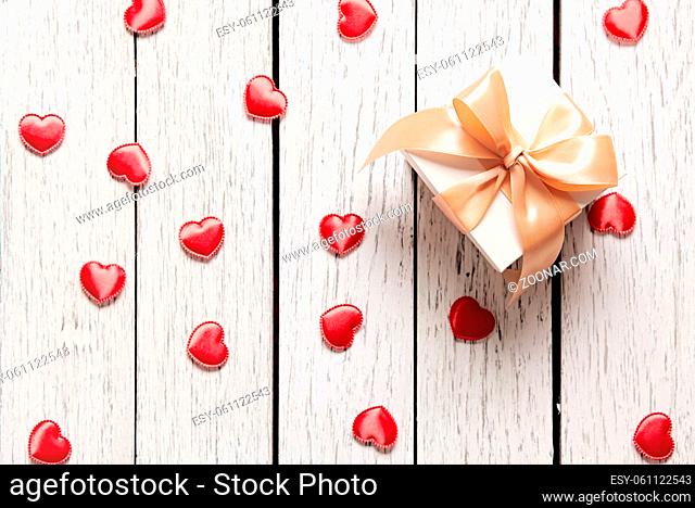 Gift box with small hearts on old white wood table