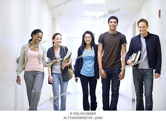 High school students walking down school corridor