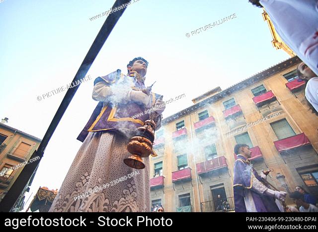 05 April 2023, Spain, Granada: Young acolytes, dressed in purple robes with golden decorations, move the censers during the procession of Cristo del Consuelo...