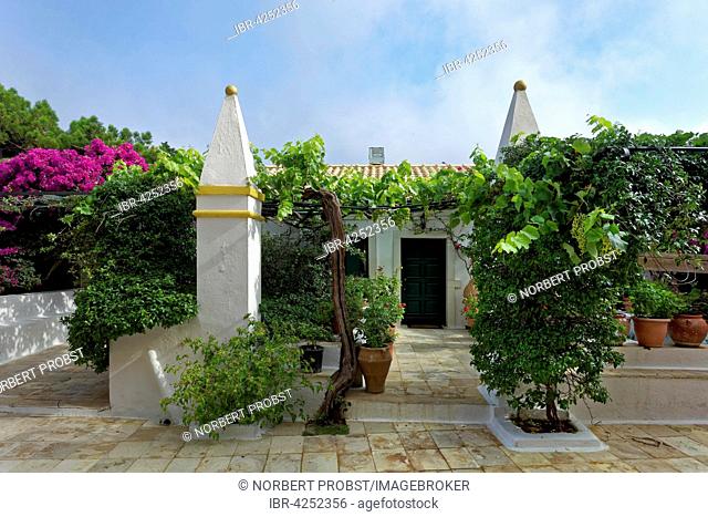 Yard with vines and obelisk in the monastery Panagia Theotokos tis Paleokastritsas or Panagia Theotokos, Paleokastritsa, Corfu, Ionian Islands, Greece