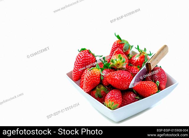Fresh organic red strawberries in a porcelain bowl