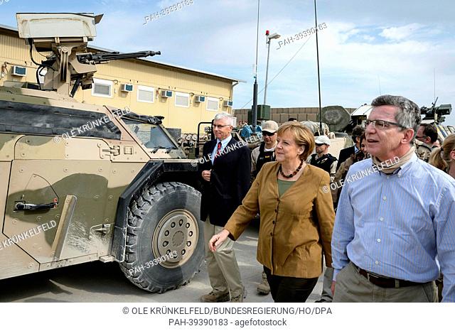 German Chancellor Angela Merkel tours the German Army field camp with German Defence Minister Thomas de Maiziere in Kunduz, Afghanistan, 10 May 2013