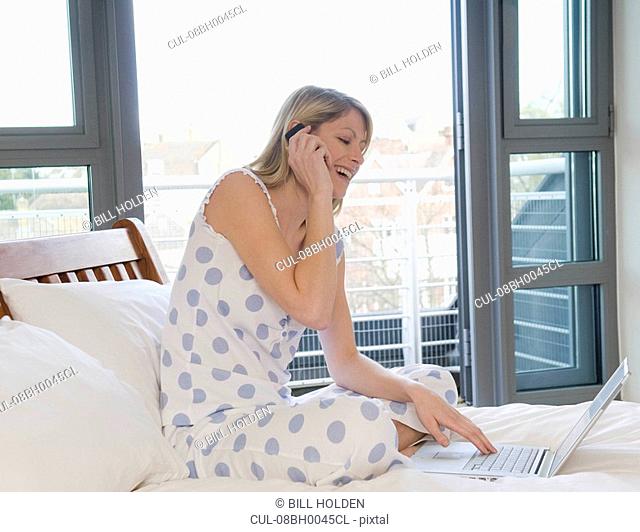 Female working from home in bed