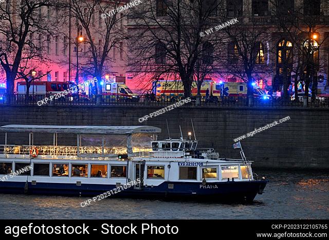 Ambulances and police at Ales Embankment, where shots were fired in the Faculty of Arts building (in background), in Prague, Czech Republic, on December 21