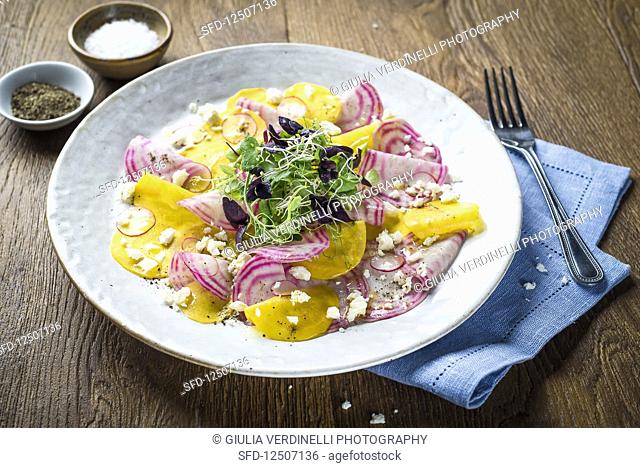 Salad with golden beets, chioggia beets, feta cheese, radishes and fresh herbs