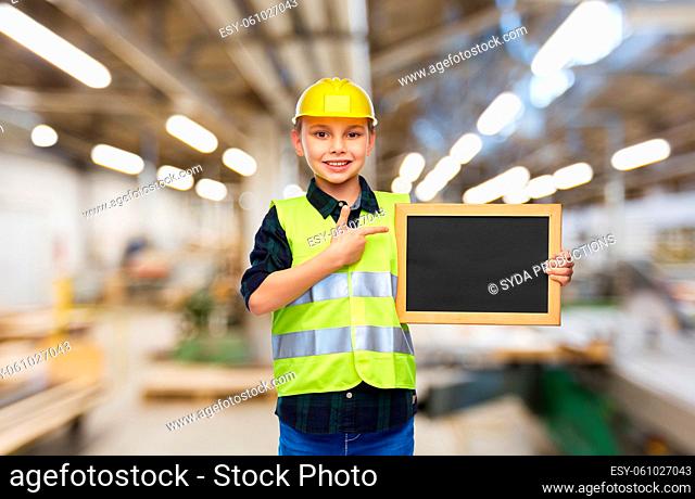 little boy in protective helmet holding chalkboard