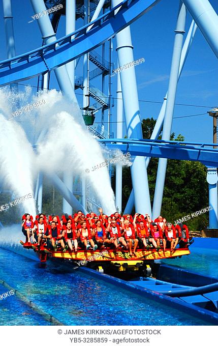 A plume of water rises from a thrill ride