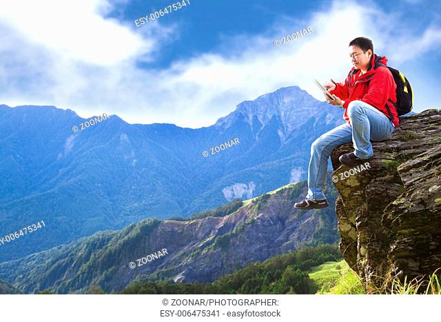 man with tablet pc on the mountain