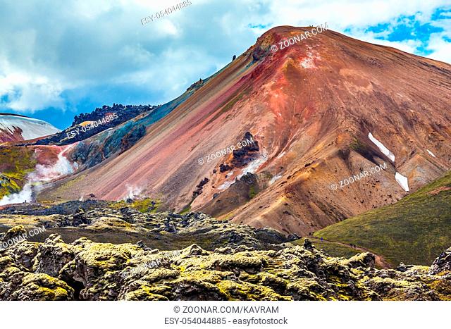 Travel to Iceland in the summer. National park Landmannalaugar. Multi-color rhyolitic mountains are lit with the July sun