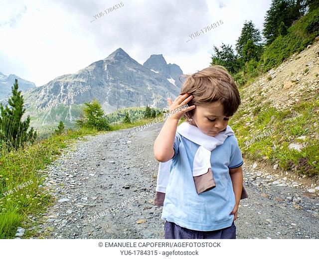 Children make an excursion in the Stelvio National Park, Purple Valley, Bormio, Lombardy, Italy