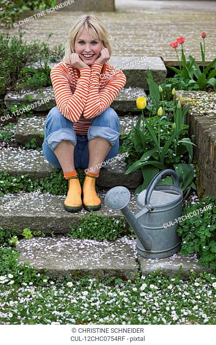 woman sitting on garden stairs