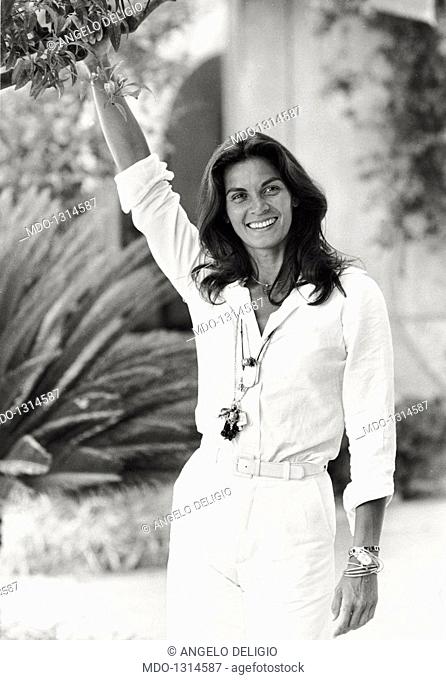 Portrait of Florinda Bolkan smiling. Portrait of Brazilian actress Florinda Bolkan smiling in a garden. Taormina, 1970s