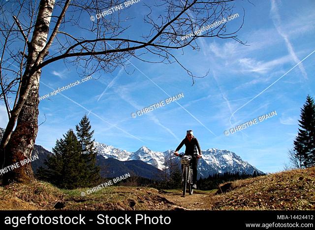 young woman riding mountain bike, Barmsee near Krün, Germany, Bavaria, Upper Bavaria, Isar Valley, bicycle, Karwendel Mountains