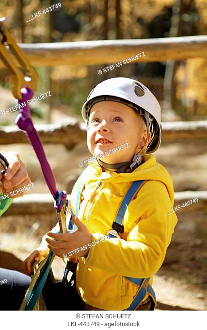 Boy in a high ropes course, Vernagt am See, Schnals Valley, South Tyrol, Italy