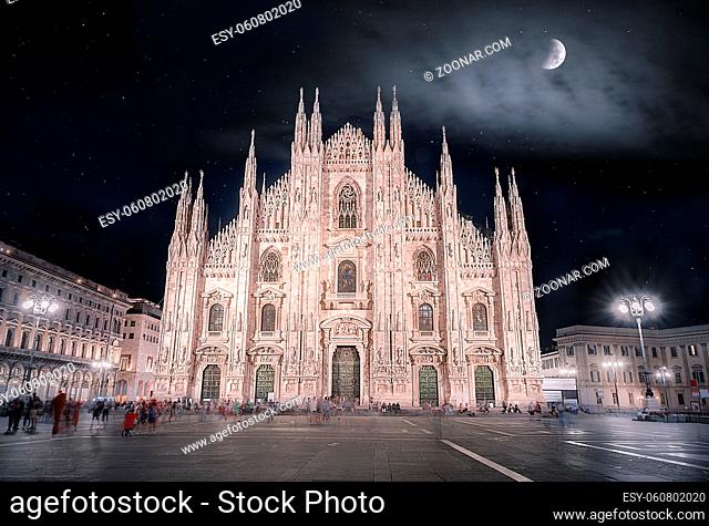 Night picture with the Cathedral of Milan, known also as the Duomo of Milan, with a beautiful sky full of stars and enlightened by the moon