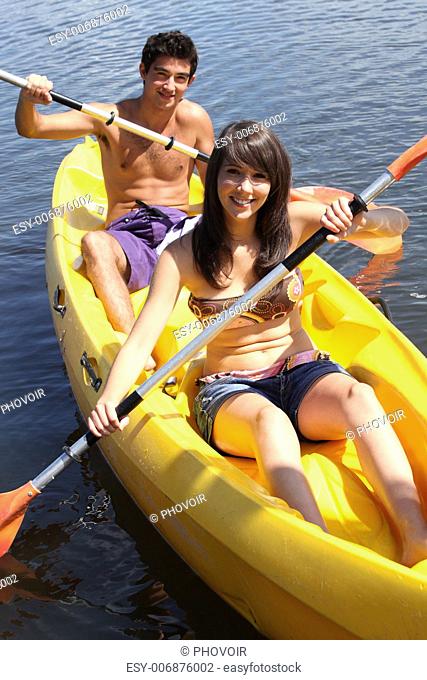 girl and boy canoeing together
