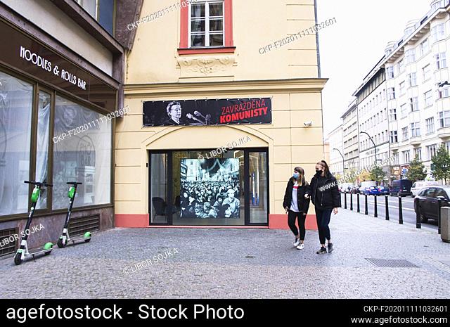 The photo of the November 17, 1989, events leading to the fall of communism in a window and a poster with a portrait of the Czech lawyer and democratic...