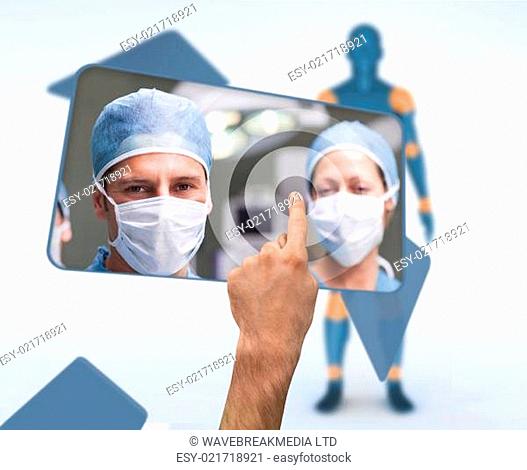 Hand selecting image of surgeons from digital interface with human figure