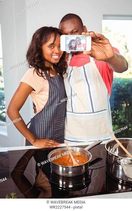 Ethnic couple taking selfie