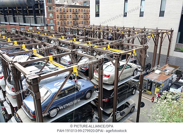 08 September 2019, US, New York: Cars are parked on a multi-storey lifting platform in a private parking lot in the Chelsea district of Manhattan