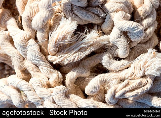 A pile of old damaged tangled rope abandoned on the ground