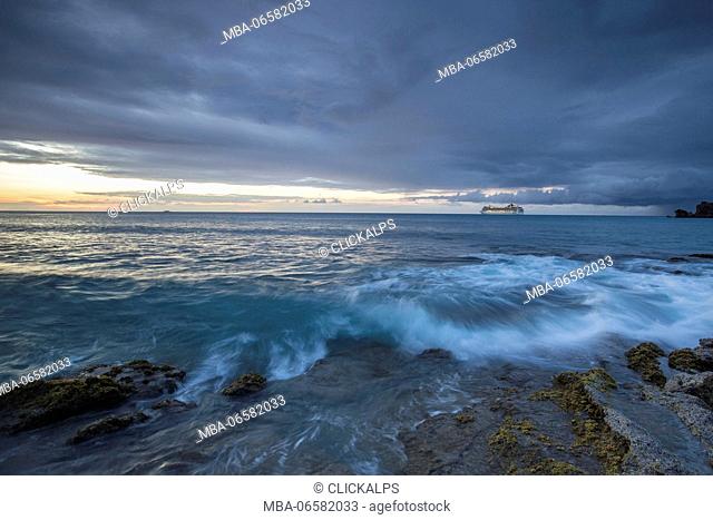 Dusk frames the waves crashing on the cliffs Galley Bay Caribbean St. John's Antigua and Barbuda Leeward Islands West Indies